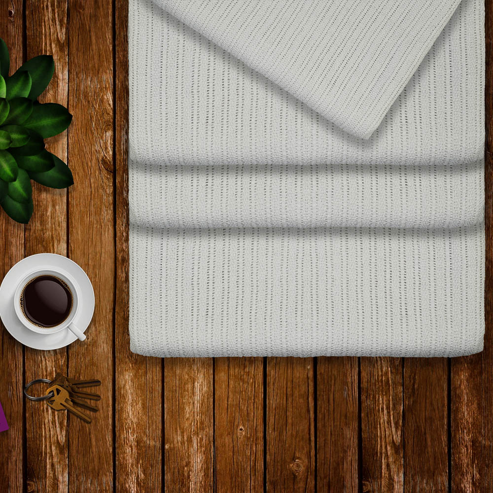 Thermal blanket draped over a bed
