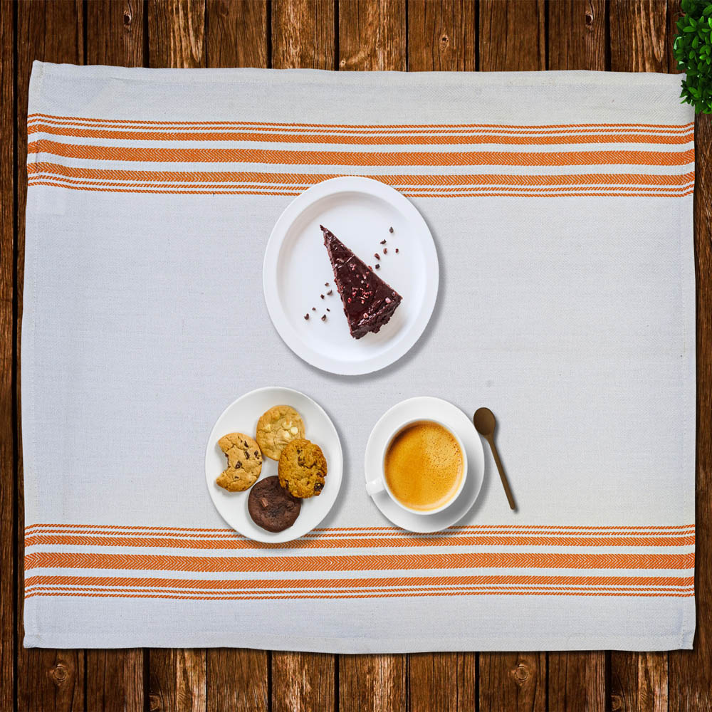 Striped placemat set on a wooden table with desserts and coffee