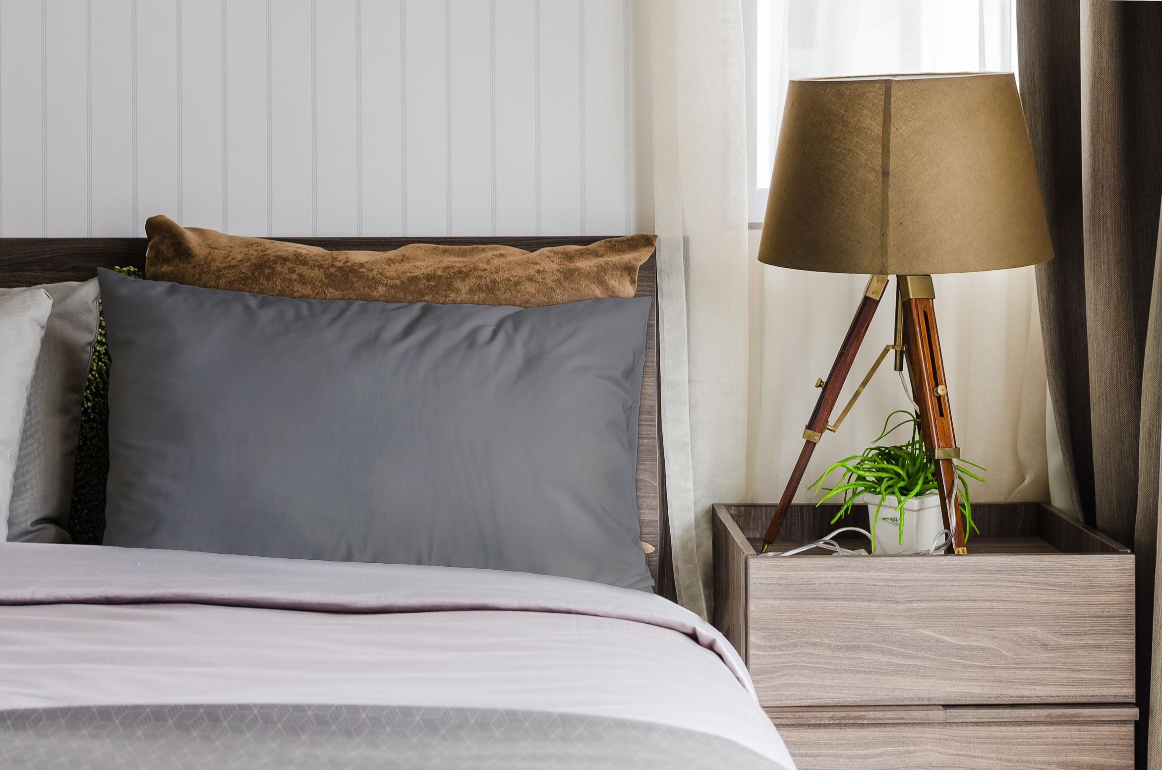Grey pillow covers styled on a bedroom bed
