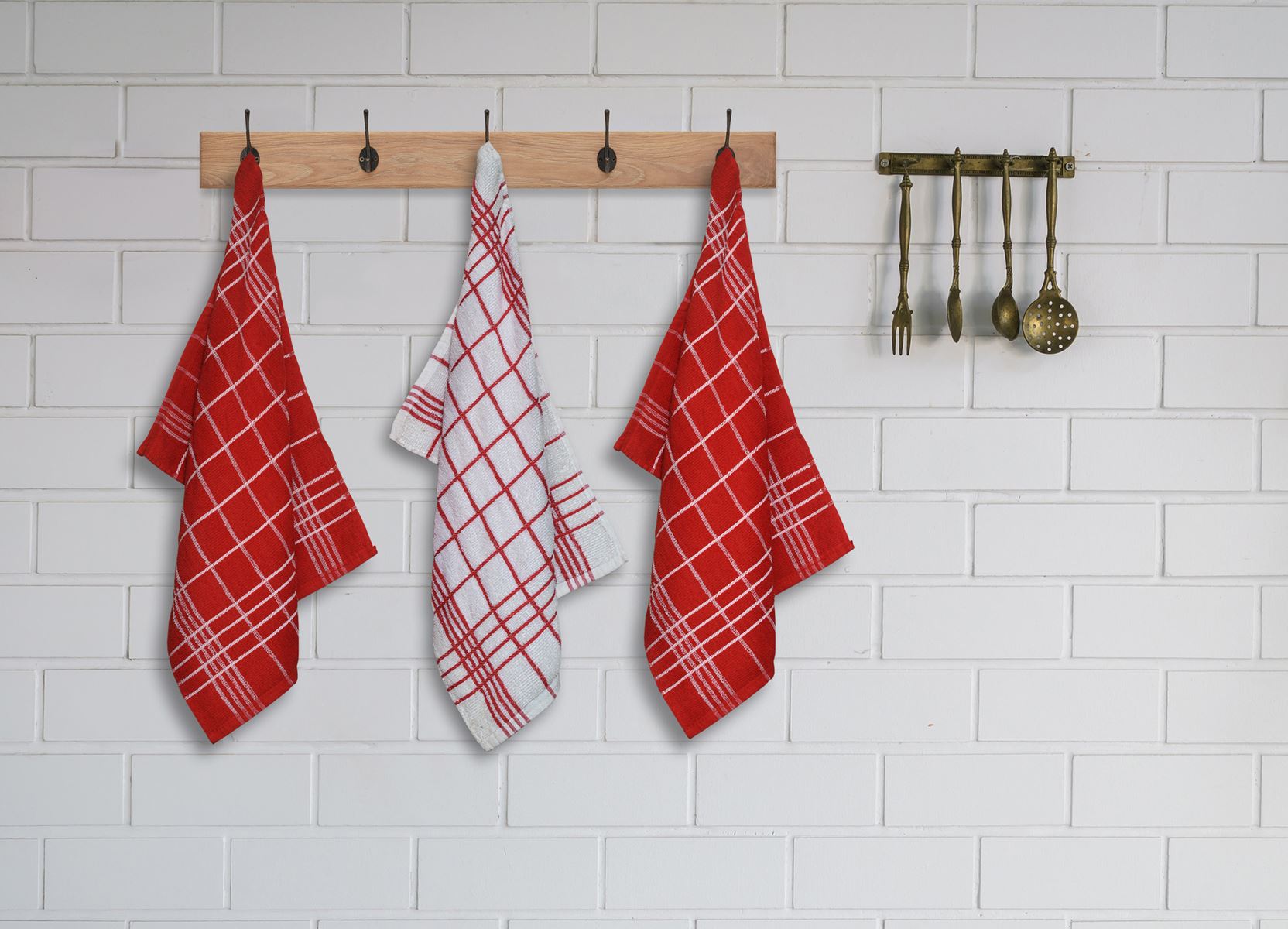 Red and white checked kitchen towels hanging on a rack