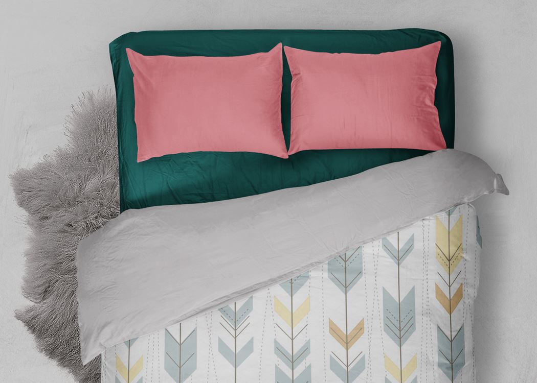 Plain pillow cover on a made bed
