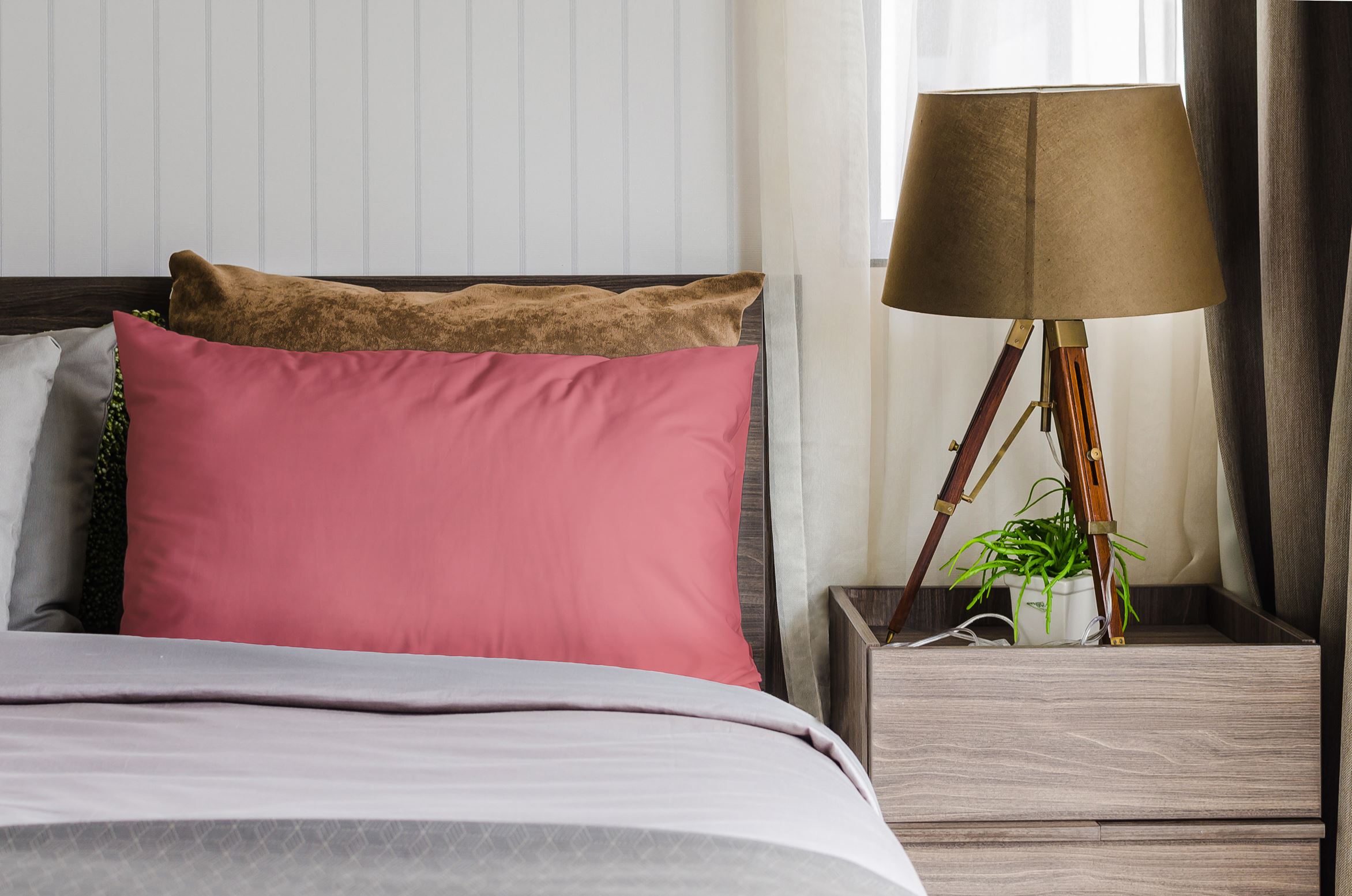 Pink pillow covers styled on a bedroom bed