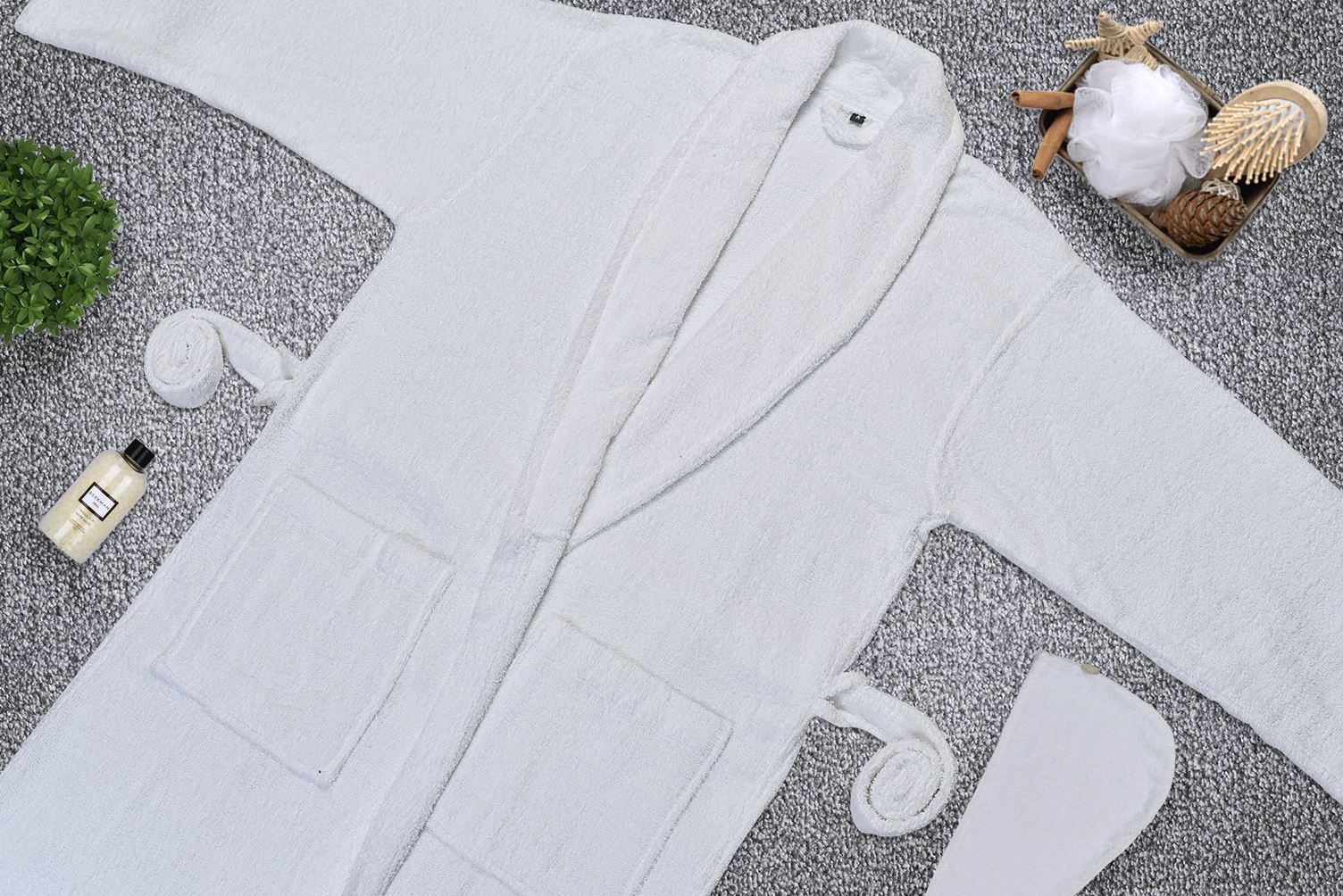Folded terry bathrobes stacked in a range of colours