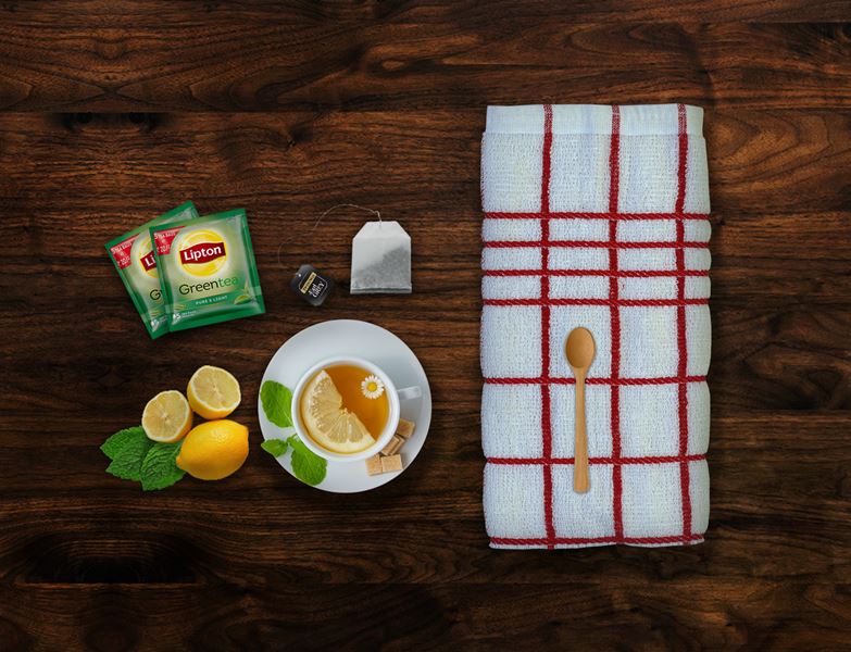 Folded white kitchen towel with woven border