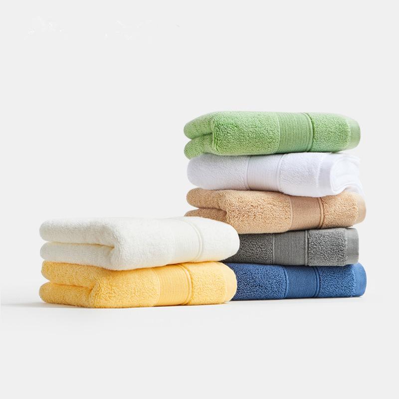 Stacks of plain dyed terry towels in pastel shades